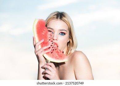 Portrait Of A Beautiful Young Blonde Woman With Blue Eyes Eating Watermelon. Sexy Blond Woman With Summer Fashion Make-up Lick Watermelon. Beauty Face.