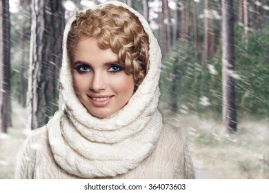 portrait of a beautiful young blonde woman on a forest background. hair tied in a braid. girl wearing a warm sweater and scarf. copy space.
 - Powered by Shutterstock