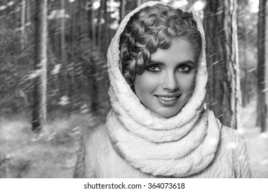 portrait of a beautiful young blonde woman on a forest background. hair tied in a braid. girl wearing a warm sweater and scarf. copy space.
 - Powered by Shutterstock