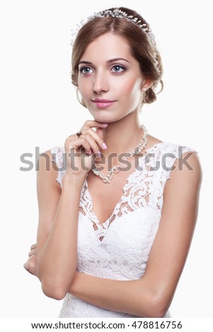 Portrait of beautiful young blonde woman bride in white Wedding Dress on light gray background