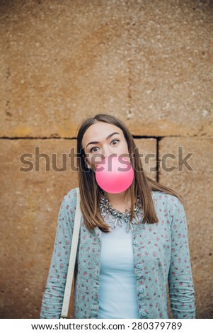 Similar – Image, Stock Photo Young teenage girl blowing pink bubble gum