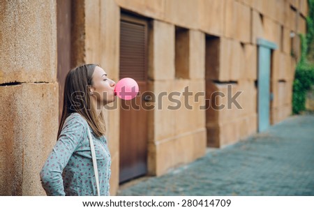 Similar – Image, Stock Photo Young teenage girl blowing pink bubble gum