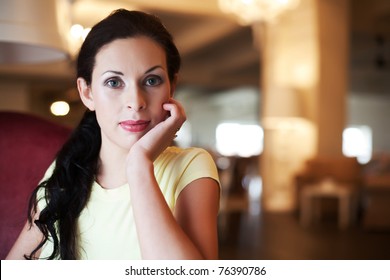 Portrait of beautiful young brunette woman - indoors