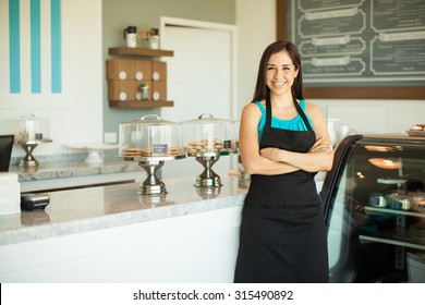 Portrait of a beautiful young business owner standing in front of her bakery and smiling