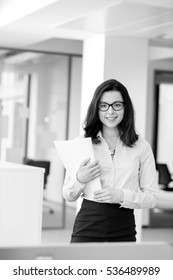 Portrait Beautiful Young Businesswoman Holding Spiral Book In Office