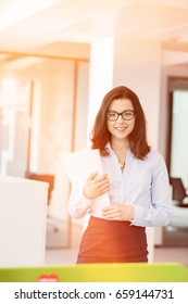 Portrait Beautiful Young Businesswoman Holding Spiral Book In Office