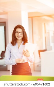 Portrait Beautiful Young Businesswoman Holding Spiral Book In Office