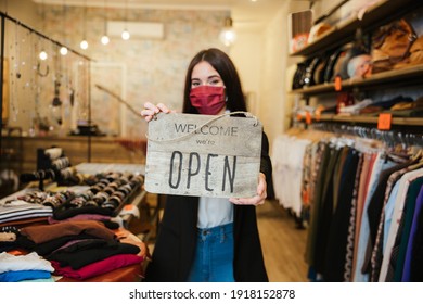 Portrait Of A Beautiful Young Clothing Store Sales Assistant Holding The 