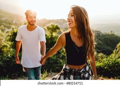 Portrait of beautiful young couple enjoying nature at mountain peak. - Shutterstock ID 480214711