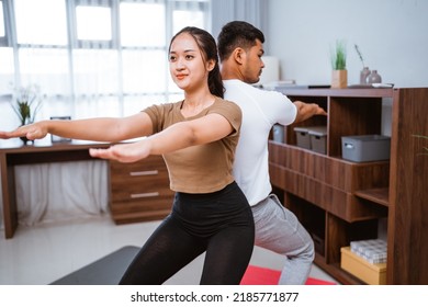 Portrait Of Beautiful Young Couple Exercising Together. Healthy Lifestyle At Home