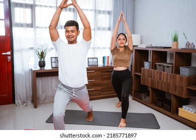 Portrait Of Beautiful Young Couple Exercising Together. Healthy Lifestyle At Home