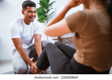 Portrait Of Beautiful Young Couple Exercising Together. Healthy Lifestyle At Home