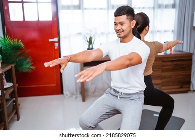 Portrait Of Beautiful Young Couple Exercising Together. Healthy Lifestyle At Home