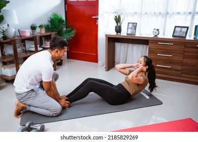 Portrait Of Beautiful Young Couple Exercising Together. Healthy Lifestyle At Home