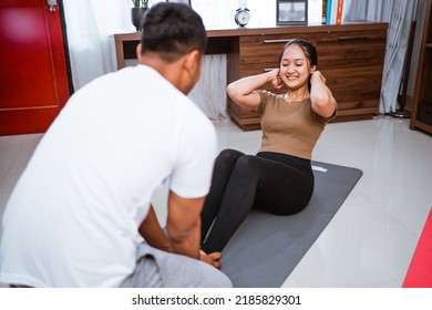 Portrait Of Beautiful Young Couple Exercising Together. Healthy Lifestyle At Home