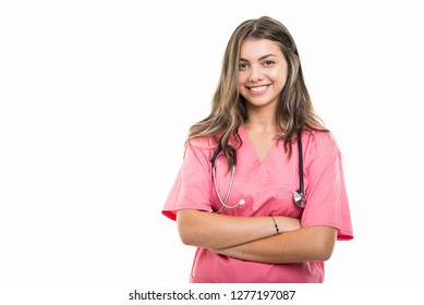 Portrait of beautiful young doctor wearing scrubs standing with arms crossed isolated on white background with copy space advertising area
