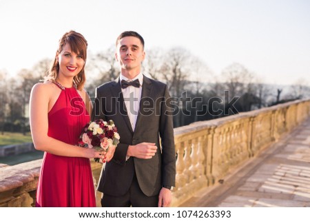 Portrait of the beautiful young elegant, happy couple who is standing outdoor together