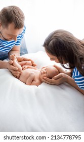 Portrait Of Beautiful Young Family Holding On Hands Cute Newborn Son, Enjoying Motherhood And Fatherhood, Happy Family ConceptNewborn Baby Portrait In Family Hands, Sleeping New Born Kid, Parents Care