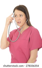 Portrait Of A Beautiful Young Female Doctor In Her Twenties Acting Silly And Playful With A Stethoscope