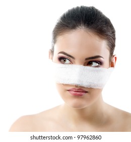 portrait of beautiful young female face with bandage on her nose - beauty treatment plastic surgery