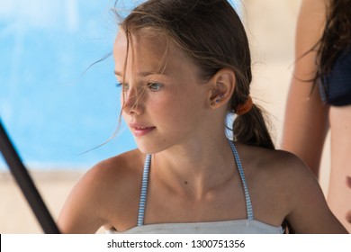 Portrait Of A Beautiful Young Girl, 9-12 Years Old, In A Swimsuit Close-up