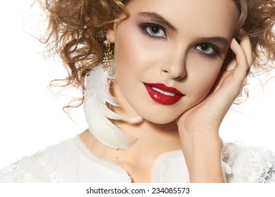Portrait of beautiful young girl with bright evening make-up perfect skin and blue eyes, red lips, nice smile blonde curly hair dressed in a white jacket with sequins on a white background in studio 