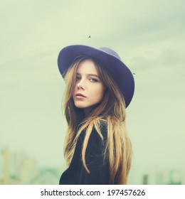 portrait of a beautiful young girl in a hat