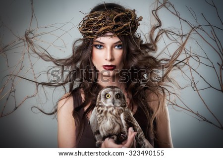 Portrait of beautiful young girl with owl 