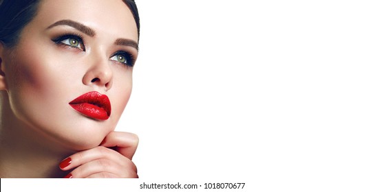 Portrait of a beautiful young girl with smooth skin, green eyes and bright red lips.