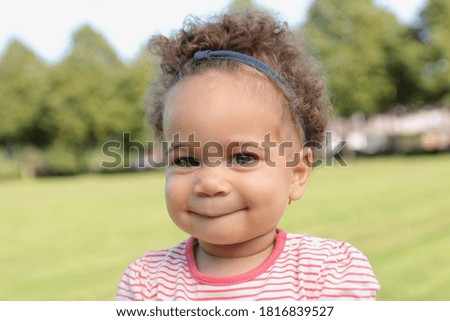 Portrait of a beautiful young happy baby outside 