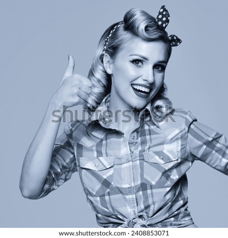 Portrait of beautiful young happy smiling woman, showing thumb up gesture in pin up style. Blond girl in retro fashion and vintage concept. Black and white. Square photo.