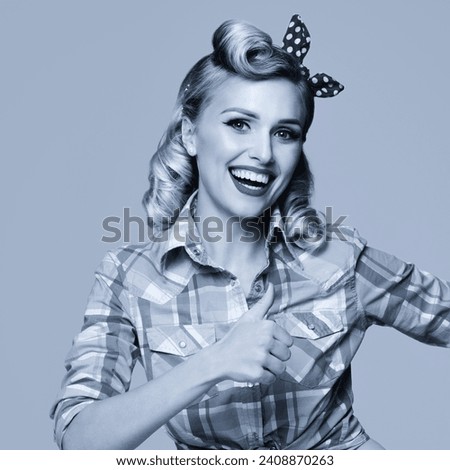 Portrait of beautiful young happy smiling woman, showing thumb up gesture, dressed in pin-up style. Blond girl in retro fashion and vintage concept. Black and white. Square photo.