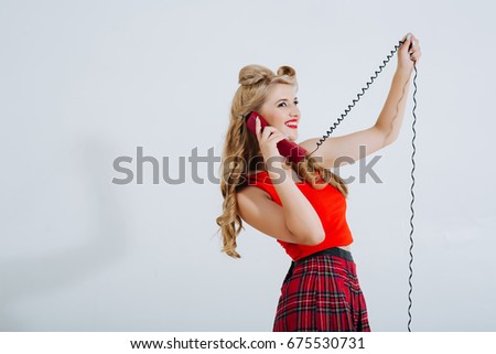 Portrait of beautiful young happy smiling woman with phone, dressed in pin-up style. Caucasian blonde model posing in retro fashion and vintage concept studio shoot. Horizontal banner composition