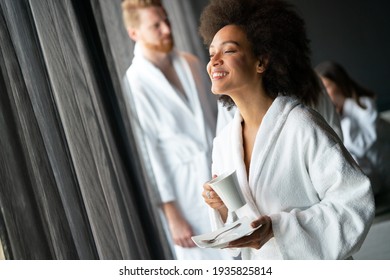 Portrait of a beautiful young healthy black woman relaxing in a robe and drinking coffee