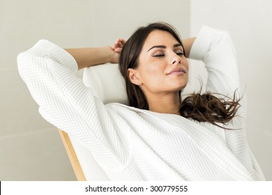 Portrait Of A Beautiful Young  Healthy Woman Relaxing In A Robe