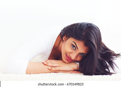 portrait of beautiful young indian woman on carpet