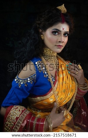 Portrait of a beautiful young Indian woman in traditional clothing and Indian accessories