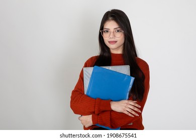 Portrait Of A Beautiful Young Lady Wearing Spectacles And Holding Business Folders Standing Against White Background, College Student Carrying Files.