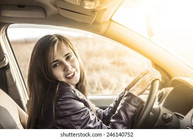 Portrait of beautiful young latin hispanic woman in the new car - indoor talking to an imaginary police, companion, companion, who asks for directions or the right to drive and Documents