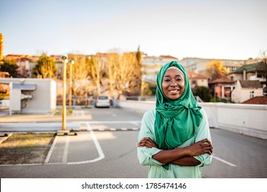 Portrait of beautiful young middle eastern woman looking at camera and natural smiling. Portrait of young muslim woman wearing hijab head scarf in city while looking at camera.  - Powered by Shutterstock