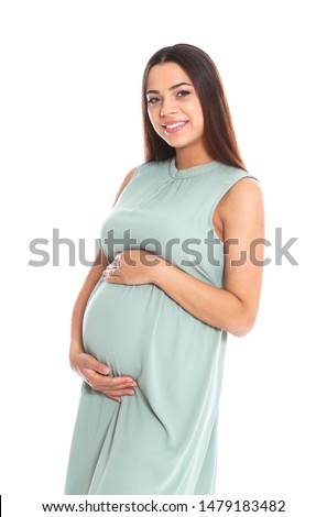 Portrait of beautiful young pregnant woman in dress on white background
