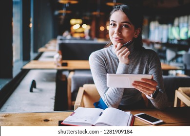 Portrait of beautiful young smiling blogger looking in camera while enjoying break at cafe and creating new publication for own website, happy hipster girl holding electronic device and chatting - Shutterstock ID 1281909184