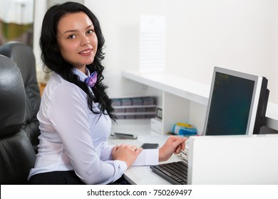 Portrait of a beautiful young smiling woman in the office