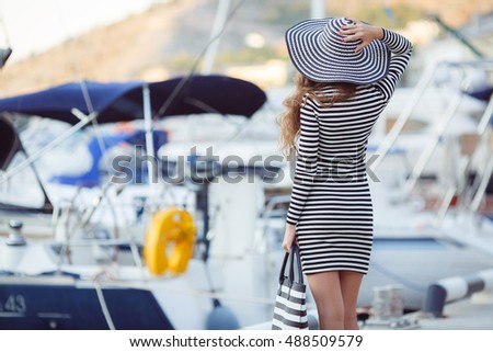 portrait of beautiful young smiling woman near the boats and yachts. Outdoors, lifestyle. Beautiful woman near the boats and yachts. Fashion. sea or ocean background