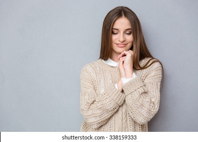 Portrait Of Beautiful Young Sweet Shy Pretty Girl In Beige Sweater Looking Down