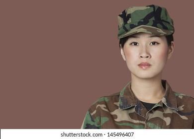 Portrait Of Beautiful Young US Marine Corps Soldier Over Brown Background