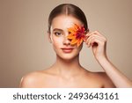 Portrait of beautiful young woman with autumn leafs. Healthy clean fresh skin natural make up beauty eyes