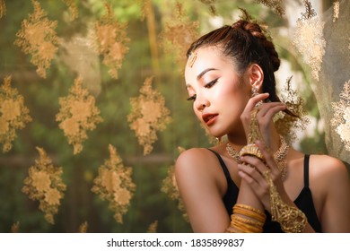 Portrait Of Beautiful Young Woman With Black And Gold Traditional India Costume And Jewelry.