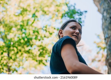 Portrait Of A Beautiful Young Woman In A Black Dress On A Background Of Summer Park