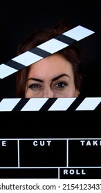 Portrait of a beautiful young woman with clapperboard, she holding clapperboard, Film production and movie making concept 